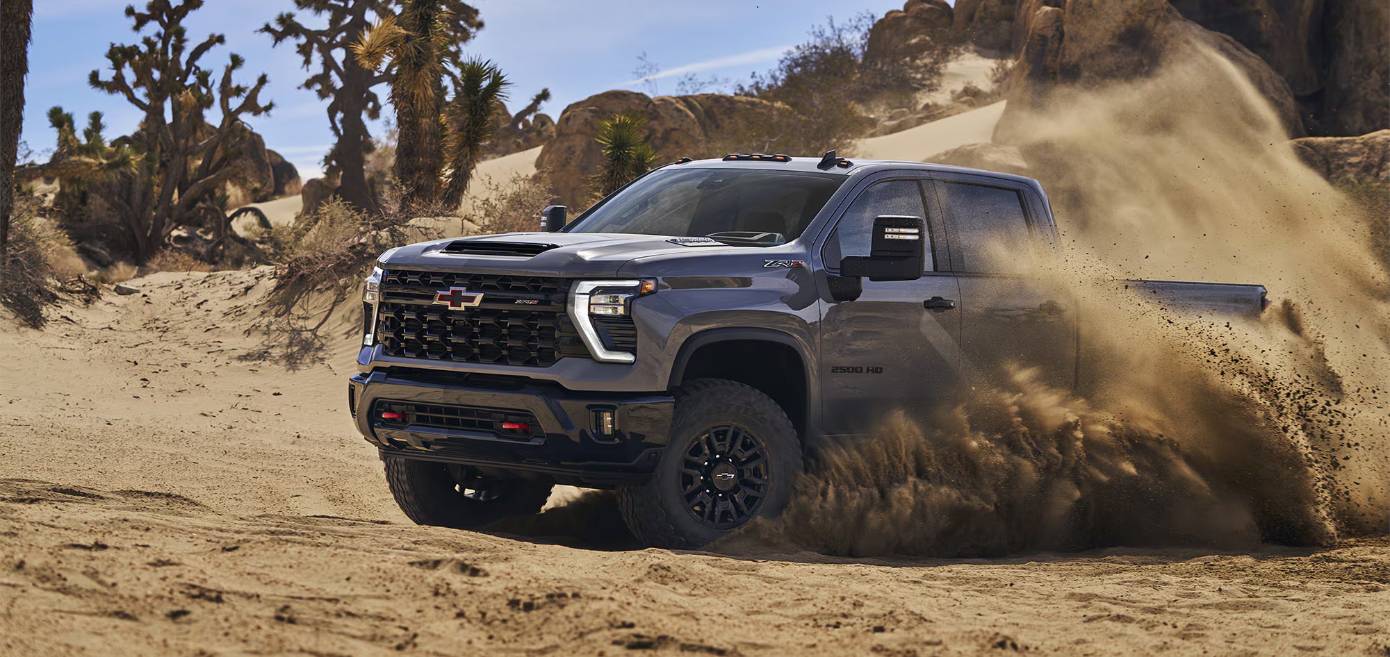 Image of a 2024 Chevy Silverado 2500 HD ZR2 driving through the desert