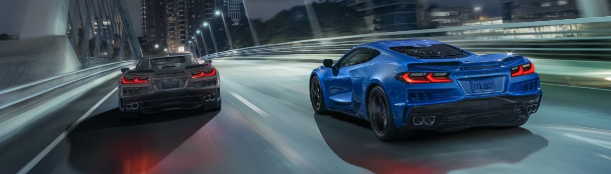 Image of a Chevrolet Corvette E-Ray from behind driving over a bridge